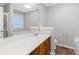 Bathroom featuring wood vanity with white countertop and a large framed mirror at 97 Spring Leaf Dr, Dallas, GA 30157