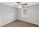 Light bedroom with neutral walls, carpet, ceiling fan and ample natural light from a large window at 97 Spring Leaf Dr, Dallas, GA 30157