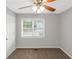 Bright bedroom featuring a ceiling fan, window with blinds, and neutral-colored walls and carpeting at 97 Spring Leaf Dr, Dallas, GA 30157