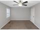 Well-lit bedroom with ceiling fan, neutral walls, and window for ample natural light at 97 Spring Leaf Dr, Dallas, GA 30157