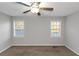 Bedroom with two windows, ceiling fan and neutral walls, creating a bright atmosphere at 97 Spring Leaf Dr, Dallas, GA 30157