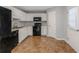 Efficient kitchen featuring white cabinets, black appliances, with an access door to the backyard at 97 Spring Leaf Dr, Dallas, GA 30157