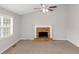 Cozy living room with a brick fireplace, ceiling fan, neutral paint, and large windows at 97 Spring Leaf Dr, Dallas, GA 30157