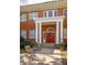 Elegant brick building featuring a grand entrance with white columns and vibrant red double doors at 138 Kirkwood Ne Rd # 9, Atlanta, GA 30317