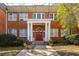 Charming brick apartment building with a welcoming red entrance door and meticulously maintained landscaping at 138 Kirkwood Ne Rd # 9, Atlanta, GA 30317