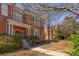 Brick building with a columned entrance and a pathway leading to the front, surrounded by greenery at 138 Kirkwood Ne Rd # 9, Atlanta, GA 30317