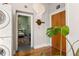 Hallway leading to a bedroom, featuring a stacked washer and dryer, and a Monstera plant at 138 Kirkwood Ne Rd # 9, Atlanta, GA 30317