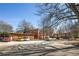 Well-maintained brick building with a paved parking lot, surrounded by mature trees at 138 Kirkwood Ne Rd # 9, Atlanta, GA 30317
