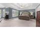 This main bedroom features a tray ceiling, large windows, neutral color palette, and ceiling fan at 313 Calla Ln, Alpharetta, GA 30005