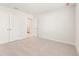 Bedroom with neutral carpet and white trim; includes ensuite bathroom and closet at 4155 Viola Pl, Atlanta, GA 30349