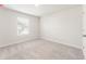 Bedroom with neutral carpet and white trim, featuring a window with natural light at 4155 Viola Pl, Atlanta, GA 30349