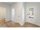 Inviting entryway showcasing wood-look flooring, a white front door with glass panes, and access to other rooms at 4155 Viola Pl, Atlanta, GA 30349