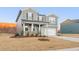Inviting two-story home showcasing gray siding, a covered front porch, and an attached garage at 5530 Rosehall Pl, Atlanta, GA 30349