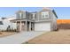 Stylish two-story home with gray siding, a covered entryway, and a spacious two-car garage at 5530 Rosehall Pl, Atlanta, GA 30349