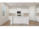 Modern kitchen featuring a center island with granite countertops and sleek white cabinetry at 5530 Rosehall Pl, Atlanta, GA 30349