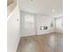 Bright living room with wood-look floors, a modern fireplace, and large windows for natural light at 5530 Rosehall Pl, Atlanta, GA 30349