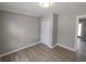 Cozy bedroom with hardwood floors, neutral paint, closet and a large window at 3230 Jamaica Nw Rd, Atlanta, GA 30318