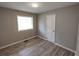 Cozy bedroom with gray walls, vinyl floors, and a window next to a closet for ample light and storage at 3230 Jamaica Nw Rd, Atlanta, GA 30318