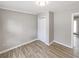 Bedroom featuring laminate floors, natural light, and a closet at 3230 Jamaica Nw Rd, Atlanta, GA 30318