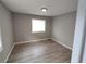 Bedroom featuring gray walls, modern vinyl flooring, and a window for natural light at 3230 Jamaica Nw Rd, Atlanta, GA 30318