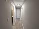 Long hallway leads to bedrooms, bathroom and utility closet with hardwood floors at 3230 Jamaica Nw Rd, Atlanta, GA 30318