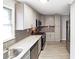 Modern kitchen with stainless steel appliances, gray cabinets, granite countertops, and tile backsplash at 3230 Jamaica Nw Rd, Atlanta, GA 30318