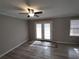 Open living room with new hardwood floors, a ceiling fan and doors leading to the outside at 3230 Jamaica Nw Rd, Atlanta, GA 30318