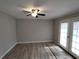 Spacious living room with modern ceiling fan and French doors leading to the outside at 3230 Jamaica Nw Rd, Atlanta, GA 30318