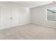 Bedroom with neutral paint, carpet, window, and closet at 4163 Viola Pl, Atlanta, GA 30349