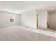 Upstairs bonus room features neutral paint, carpet, and natural light from the large window at 4163 Viola Pl, Atlanta, GA 30349