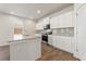 This kitchen features white cabinets, stainless appliances, granite countertops and hardwood flooring at 4163 Viola Pl, Atlanta, GA 30349