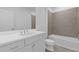 Modern bathroom featuring a white vanity, neutral tiling in shower, and large mirror at 482 Hammons Way, Atlanta, GA 30315