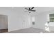 Bright bedroom featuring neutral carpet, a ceiling fan, and three windows at 482 Hammons Way, Atlanta, GA 30315