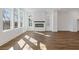 Sun-filled living room featuring fireplace, hardwood floors, and several windows at 482 Hammons Way, Atlanta, GA 30315