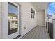 Covered porch featuring wood style deck, a door, and black railings at 482 Hammons Way, Atlanta, GA 30315