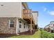 Townhouse backyard showing a small patio and lush green landscaping with multi-level decks at 6080 Indian Wood Se Cir, Mableton, GA 30126