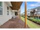 View of townhouse backyard and landscaping, with wood supports underneath deck and adjacent units at 6080 Indian Wood Se Cir, Mableton, GA 30126