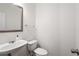 Bathroom with a white sink, toilet, and a large mirror at 6080 Indian Wood Se Cir, Mableton, GA 30126