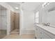 Bright bathroom features a tiled shower, soaking tub, and neutral tile floors at 6080 Indian Wood Se Cir, Mableton, GA 30126