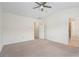 Spacious carpeted bedroom features a ceiling fan and an attached bathroom at 6080 Indian Wood Se Cir, Mableton, GA 30126