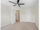 Neutral bedroom features a ceiling fan, plush carpet, and a glimpse of the attached bathroom at 6080 Indian Wood Se Cir, Mableton, GA 30126