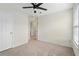 Carpeted bedroom with a ceiling fan and two windows at 6080 Indian Wood Se Cir, Mableton, GA 30126