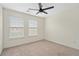 Bedroom featuring two windows, a ceiling fan, and neutral carpet at 6080 Indian Wood Se Cir, Mableton, GA 30126