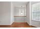 Upstairs hallway features wood floors, railing, decorative pendant light, and natural light from windows at 6080 Indian Wood Se Cir, Mableton, GA 30126