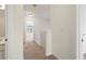 Hallway with neutral carpeting, access to bathroom and bedrooms at 6080 Indian Wood Se Cir, Mableton, GA 30126