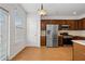 Bright kitchen with stainless steel appliances, dark cabinets, and wood floors at 6080 Indian Wood Se Cir, Mableton, GA 30126