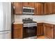 Close up of a well-equipped kitchen featuring stainless steel appliances and wood cabinets at 6080 Indian Wood Se Cir, Mableton, GA 30126