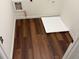 Small laundry room with wood look flooring and tray at 6080 Indian Wood Se Cir, Mableton, GA 30126