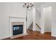 Bright living room featuring a fireplace, hardwood floors, and a staircase to the upper level at 6080 Indian Wood Se Cir, Mableton, GA 30126