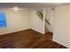 Bright living room features wood floors and a staircase at 6080 Indian Wood Se Cir, Mableton, GA 30126